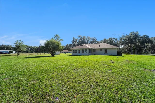 a view of an house with a big yard