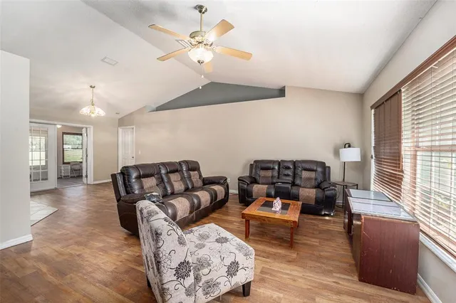 a living room with furniture and wooden floor