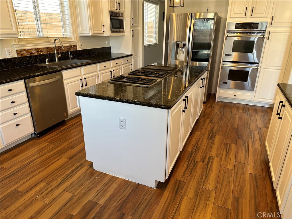 1035 Avenue D Redondo Beach, CA 90277 - Photo 22 of 66 a kitchen with granite countertop a sink and a stove top oven