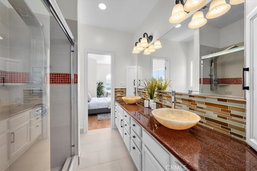 1035 Avenue D Redondo Beach, CA 90277 - Photo 57 of 66 a spacious bathroom with a granite countertop sink a toilet a mirror and vanity