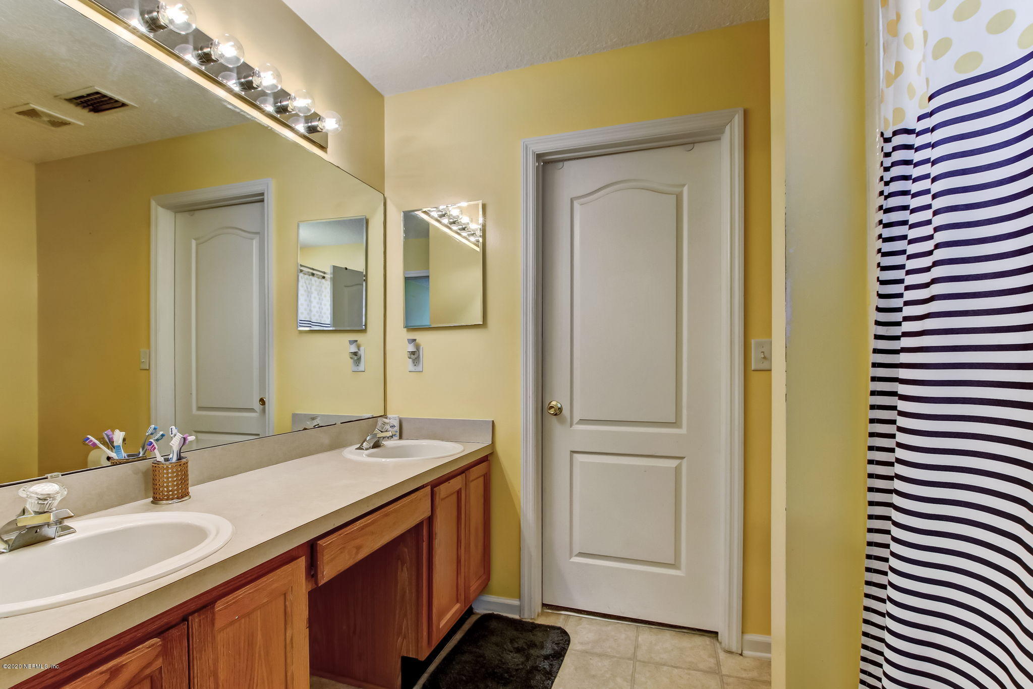 2499 Paris Mill Road Jacksonville, FL 32221 - Photo 33 of 60 a bathroom with a double vanity sink and a mirror