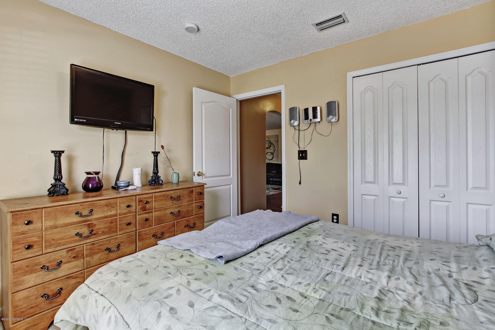 2499 Paris Mill Road Jacksonville, FL 32221 - Photo 40 of 60 a bed room with a bed a television and a dresser