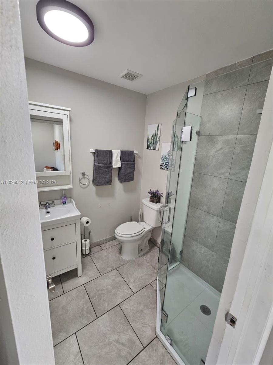 2224 Southwest 11th Street, Unit 3 Miami, FL 33135 - Photo 12 of 15 a bathroom with a sink a toilet and shower