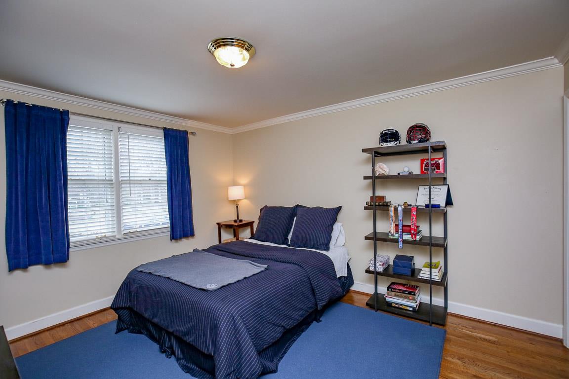 143 Alton Road Nashville, TN 37205 - Photo 16 of 25 a bedroom with a bed and a book shelf