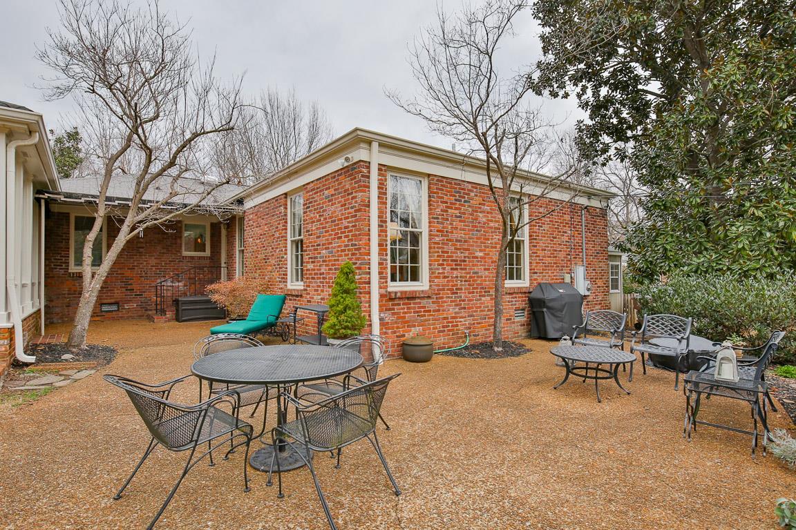 143 Alton Road Nashville, TN 37205 - Photo 24 of 25 a backyard of a house with table and chairs