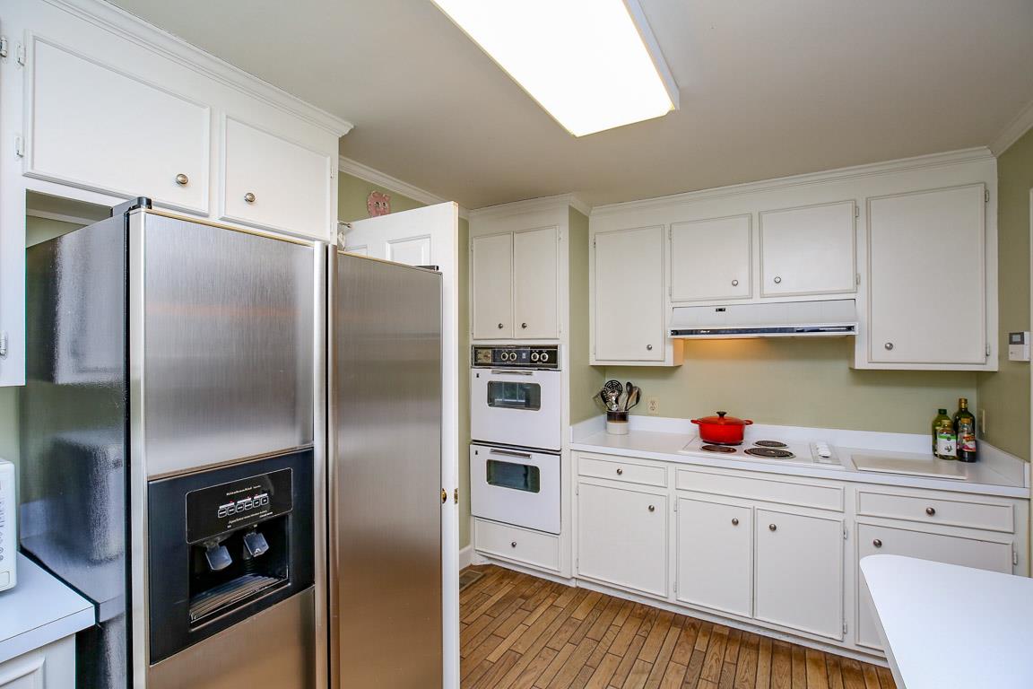 143 Alton Road Nashville, TN 37205 - Photo 8 of 25 a kitchen with cabinets stainless steel appliances and a refrigerator
