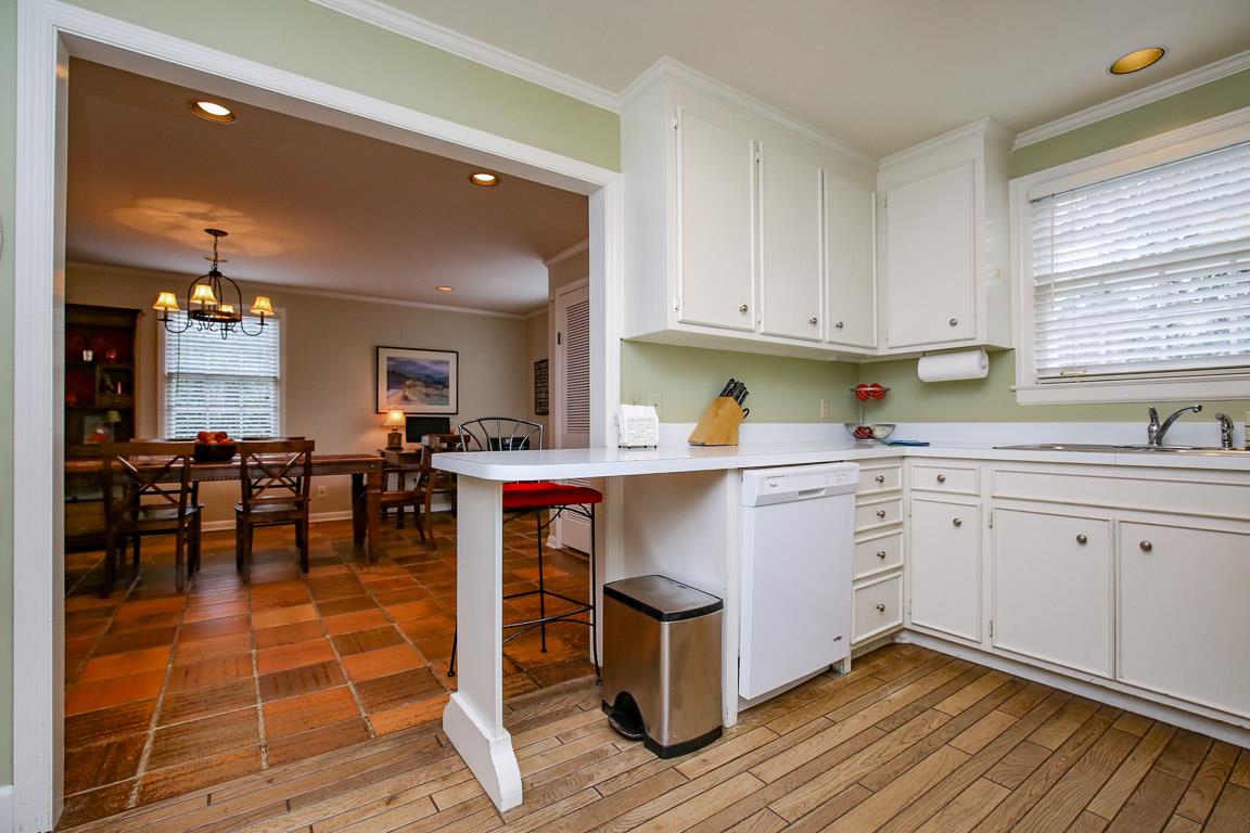 143 Alton Road Nashville, TN 37205 - Photo 9 of 25 a kitchen with sink cabinets and dining table chair