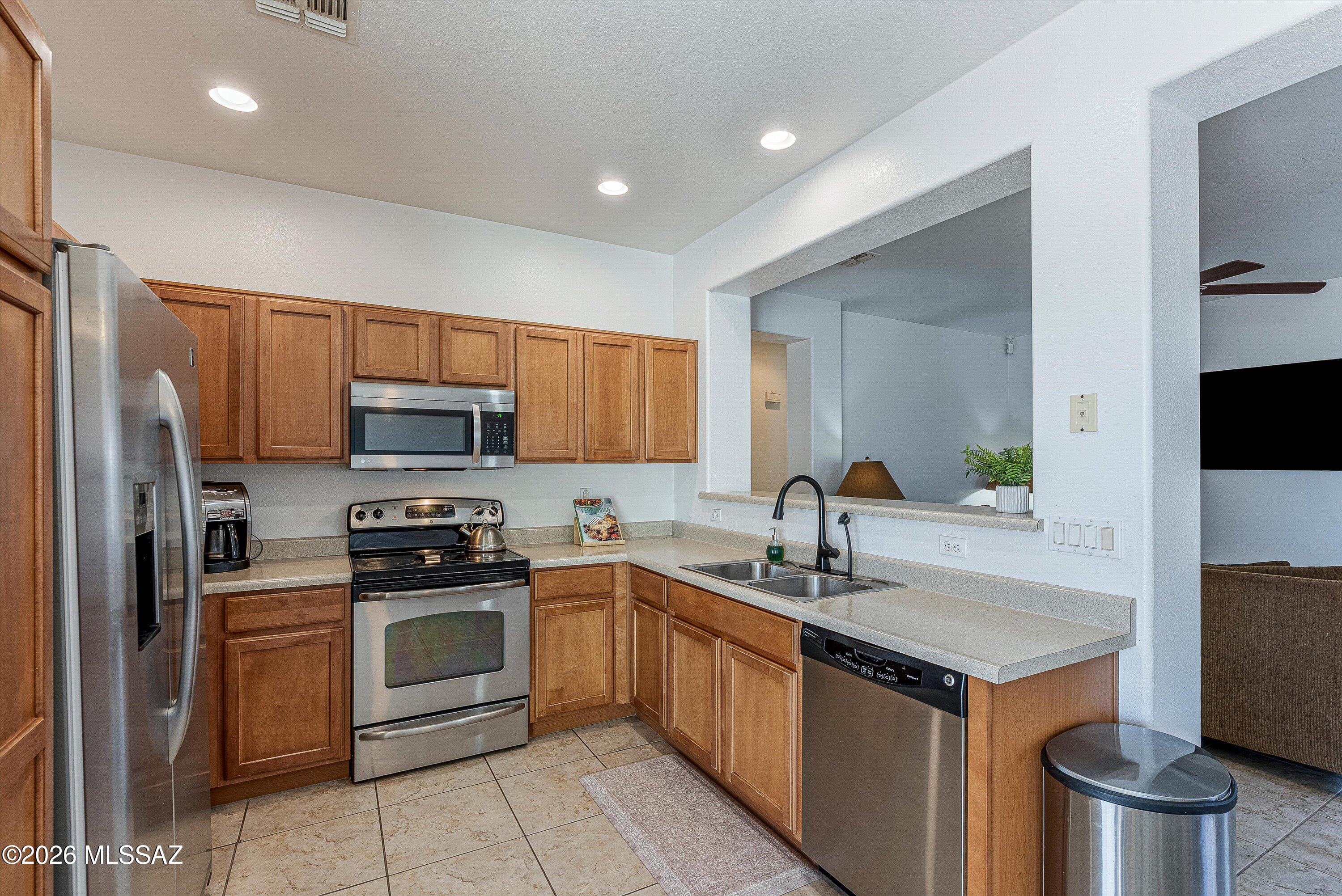 21163 East Treasure Road Red Rock, AZ 85145 - Photo 10 of 35 a kitchen with stainless steel appliances a sink stove and refrigerator