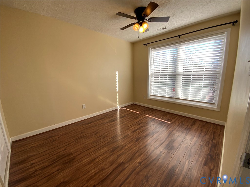 2708 Goyne Loop Chester, VA 23831 - Photo 16 of 17 Empty room with a textured ceiling, wood finished