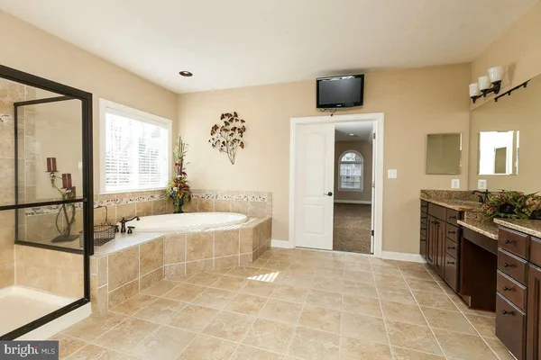 a large bathroom with a double vanity sink and a mirror