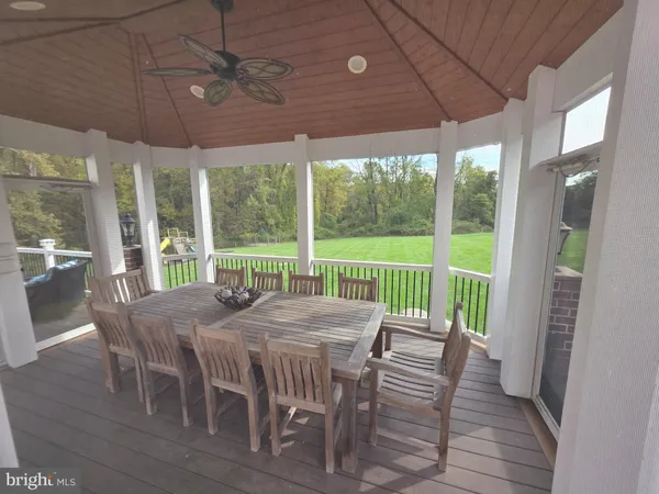 a view of a dining room with furniture large windows and wooden floor
