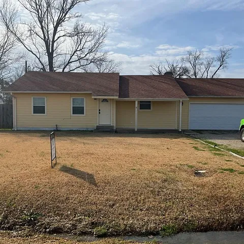 a house that has a tree in front of it
