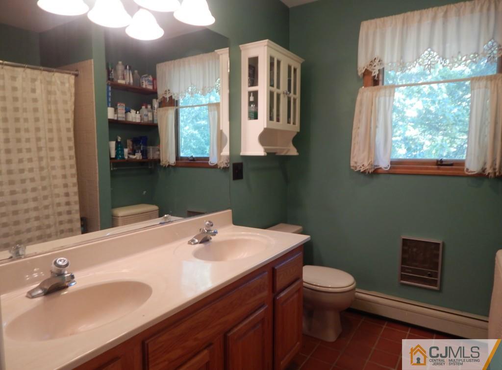 45 B Line Road Holmdel, NJ 07733 - Photo 14 of 21 a bathroom with a sink a toilet and mirror