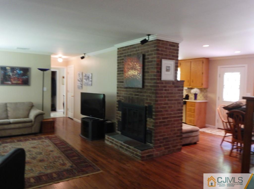 45 B Line Road Holmdel, NJ 07733 - Photo 8 of 21 a living room with furniture wooden floor and a flat screen tv