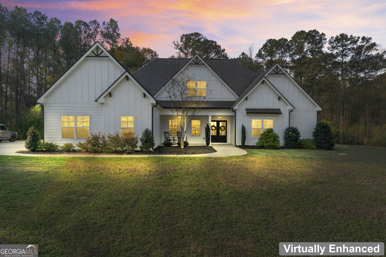 1058 Lawshe Road Senoia, GA 30276 - Photo 1 of 48 a front view of a house with a garden and porch