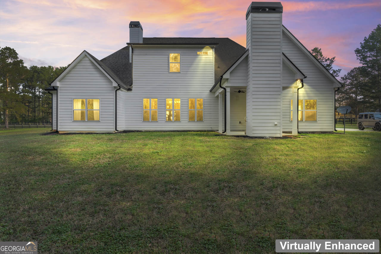 1058 Lawshe Road Senoia, GA 30276 - Photo 11 of 48 a front view of house with yard and trees in the background