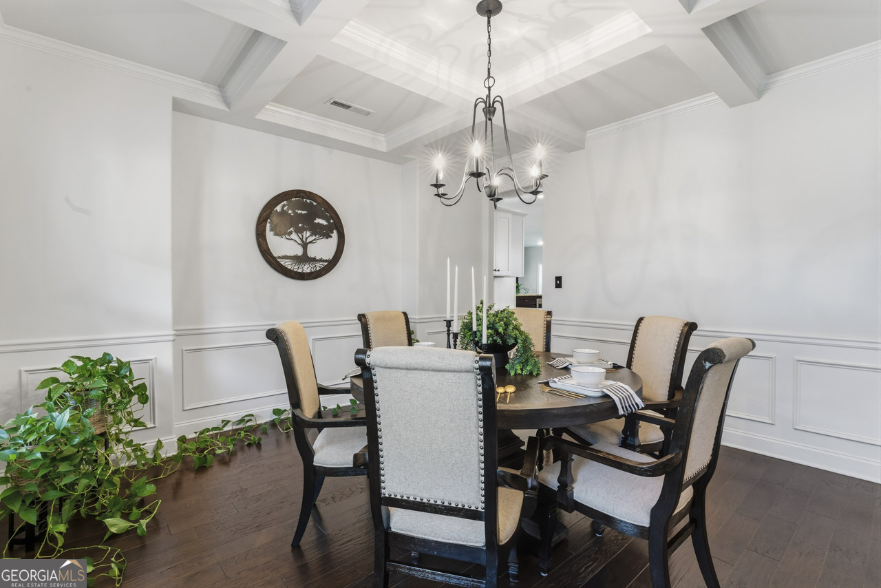 1058 Lawshe Road Senoia, GA 30276 - Photo 17 of 48 a view of a dining room with furniture a chandelier and wooden floor