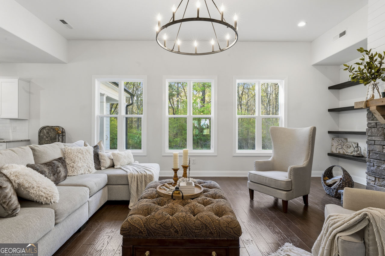 1058 Lawshe Road Senoia, GA 30276 - Photo 19 of 48 a living room with furniture and a large window
