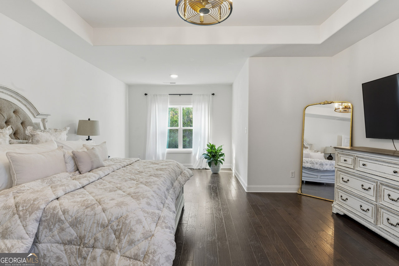 1058 Lawshe Road Senoia, GA 30276 - Photo 22 of 48 a bedroom with a bed and wooden floor