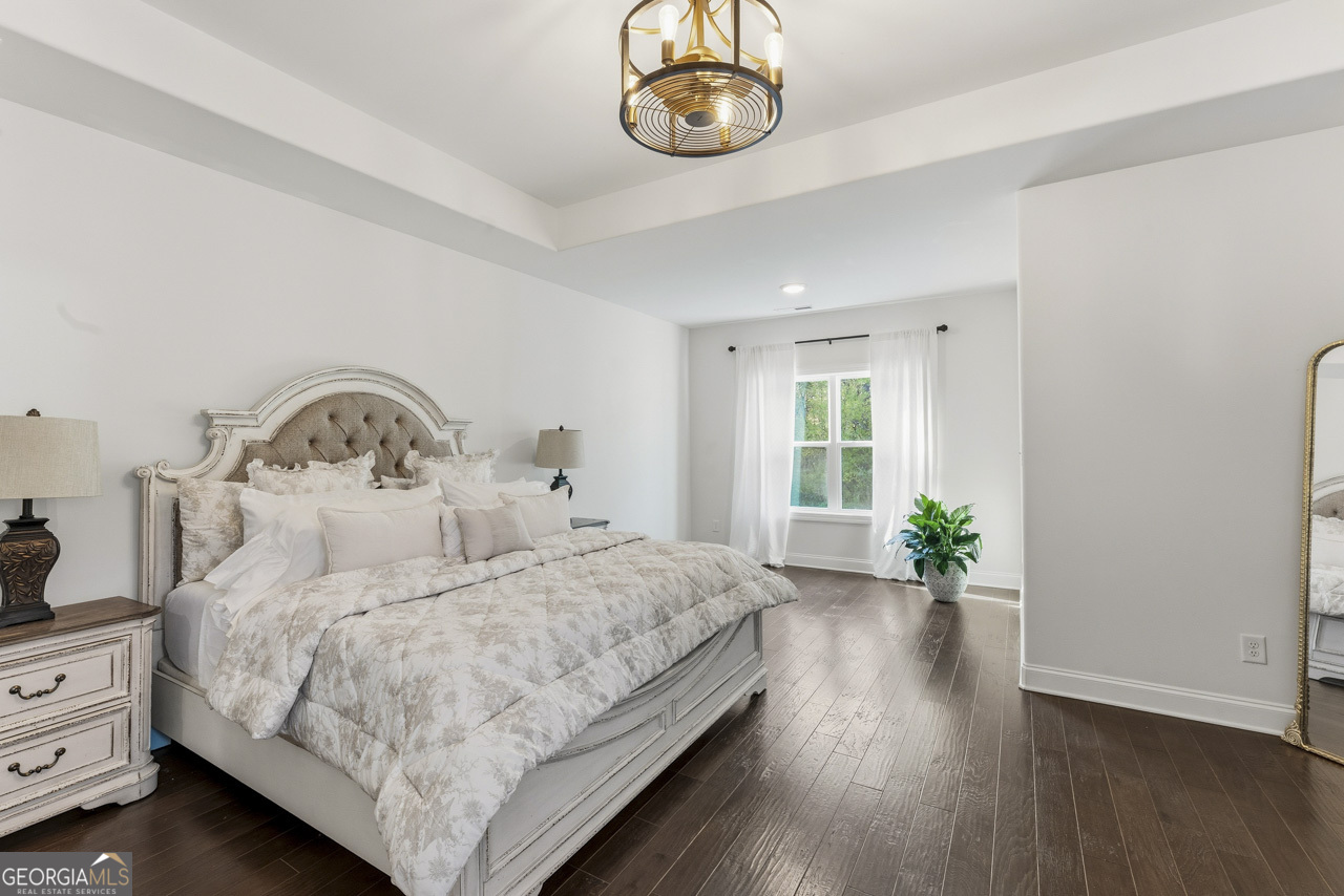 1058 Lawshe Road Senoia, GA 30276 - Photo 23 of 48 a bedroom with a bed and a potted plant