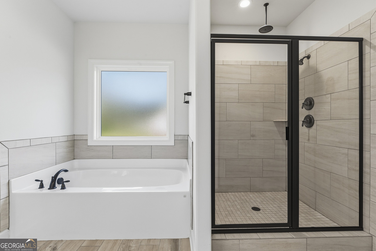 1058 Lawshe Road Senoia, GA 30276 - Photo 25 of 48 a bathroom with a bathtub and a shower