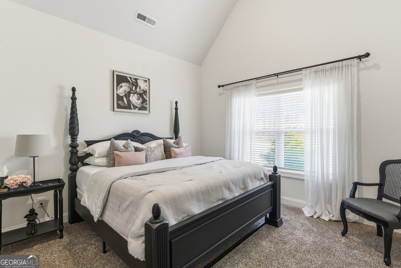 1058 Lawshe Road Senoia, GA 30276 - Photo 28 of 48 a bed room with a bed and a chair