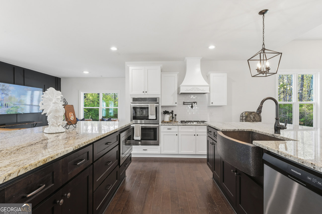 1058 Lawshe Road Senoia, GA 30276 - Photo 30 of 48 a kitchen with stainless steel appliances granite countertop sink stove and refrigerator