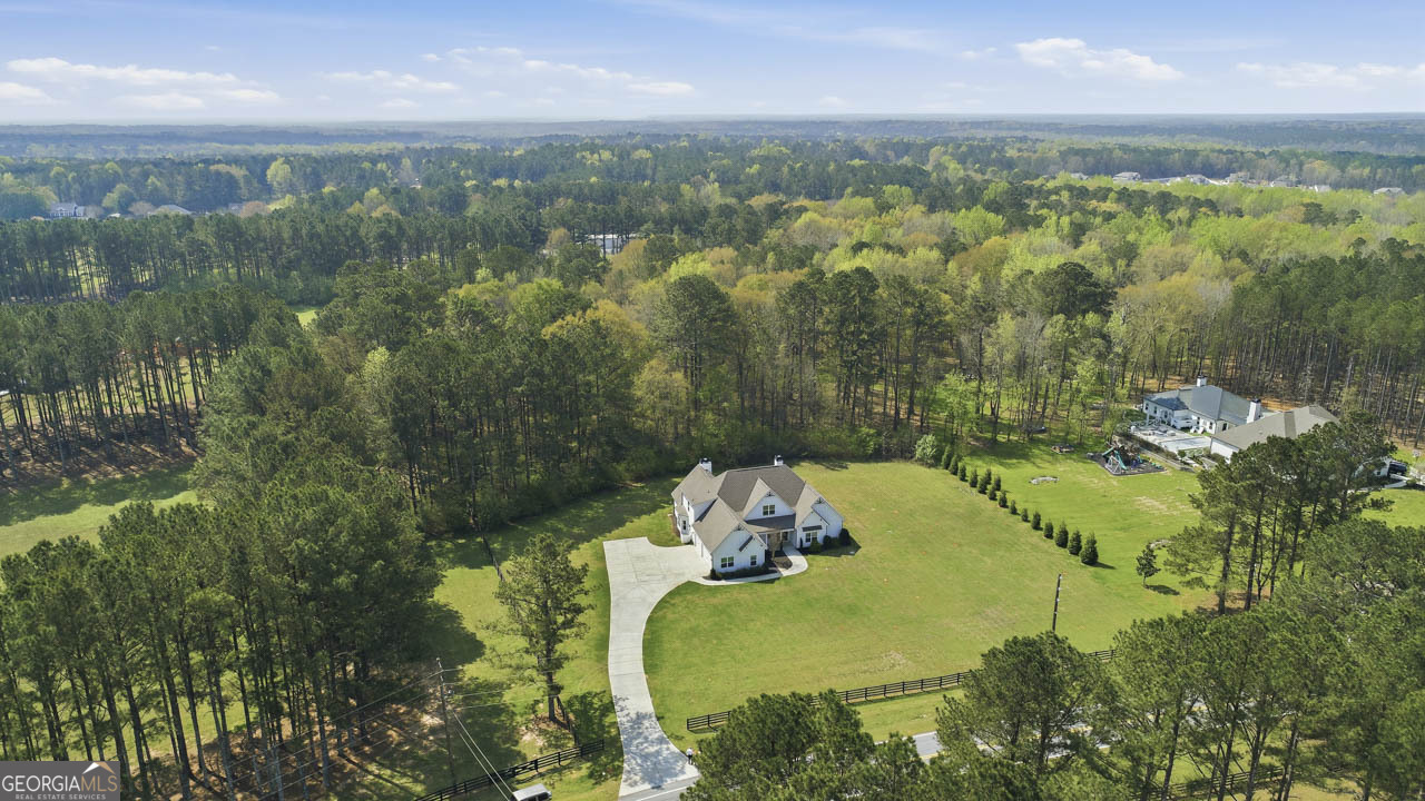 1058 Lawshe Road Senoia, GA 30276 - Photo 3 of 48 an aerial view of a residential houses with outdoor space and trees all around