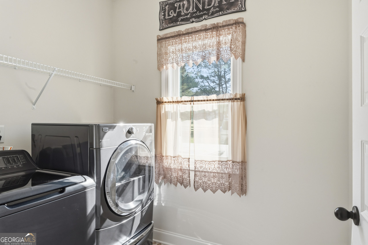 1058 Lawshe Road Senoia, GA 30276 - Photo 34 of 48 a utility room with dryer and washer
