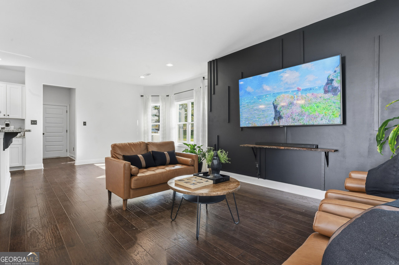 1058 Lawshe Road Senoia, GA 30276 - Photo 37 of 48 a living room with furniture and a flat screen tv