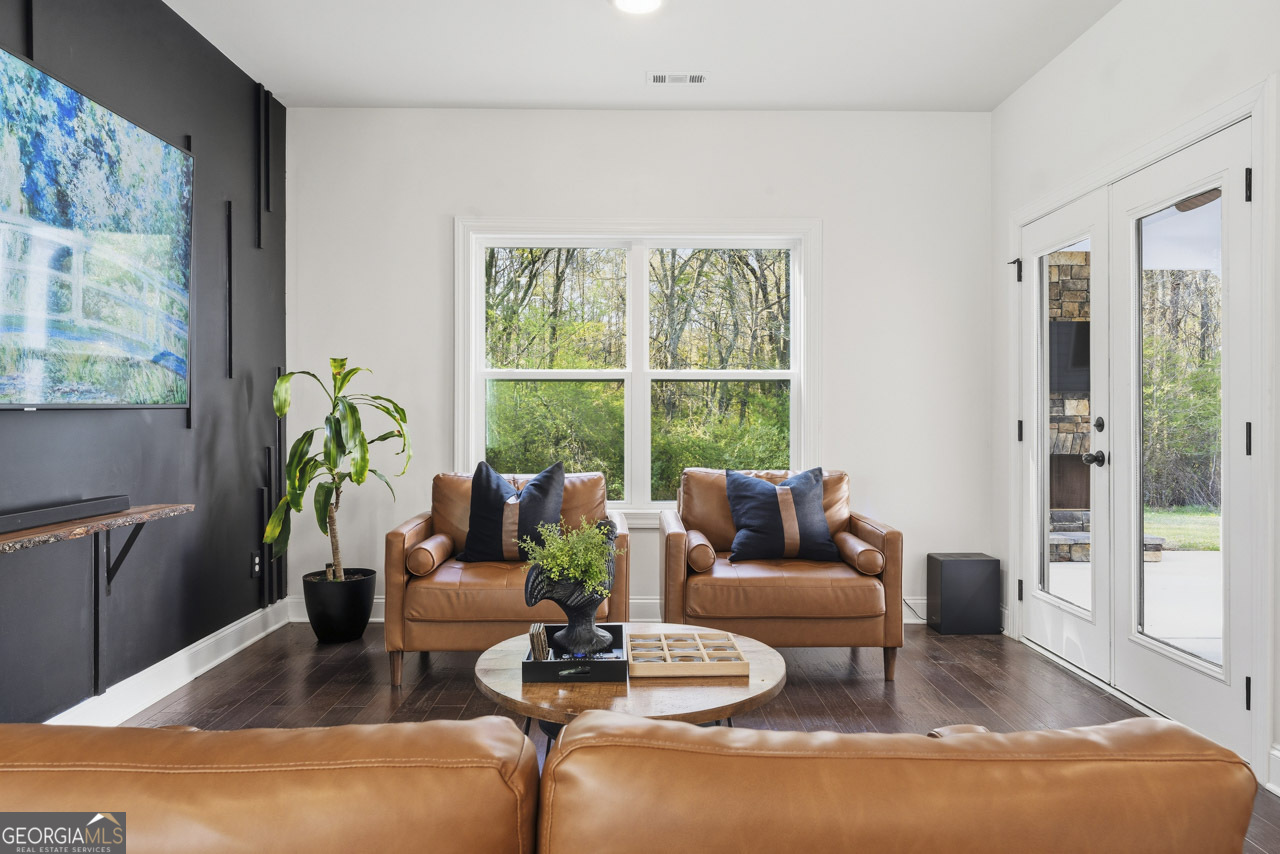 1058 Lawshe Road Senoia, GA 30276 - Photo 38 of 48 a living room with furniture and a large window
