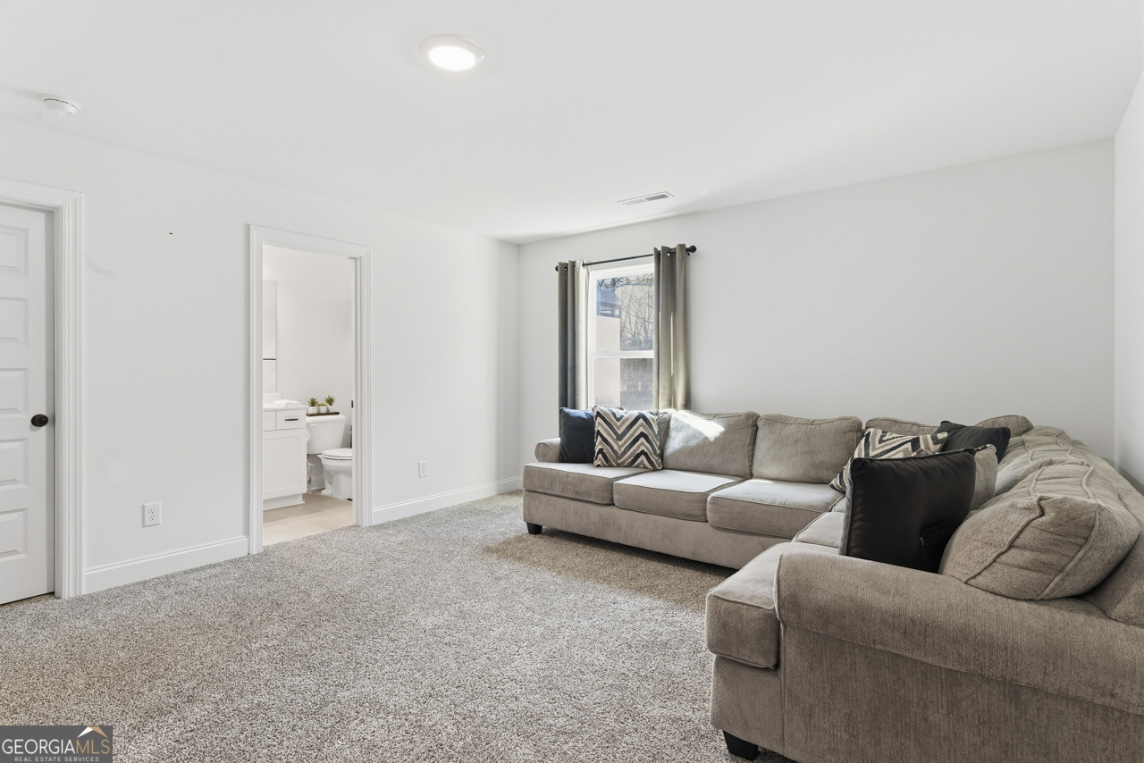 1058 Lawshe Road Senoia, GA 30276 - Photo 44 of 48 a living room with furniture and a couch