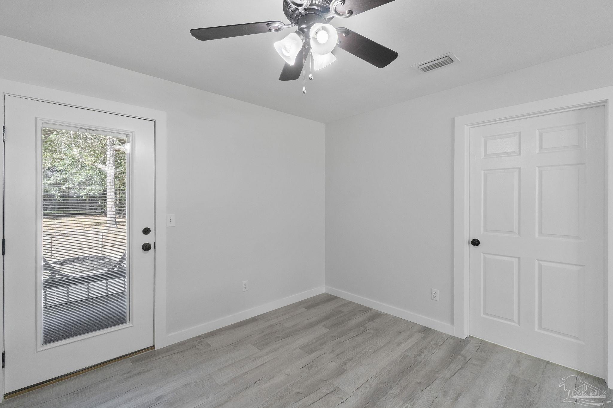 7253 Pro Lane Milton, FL 32570 - Photo 12 of 33 a view of empty room with wooden floor