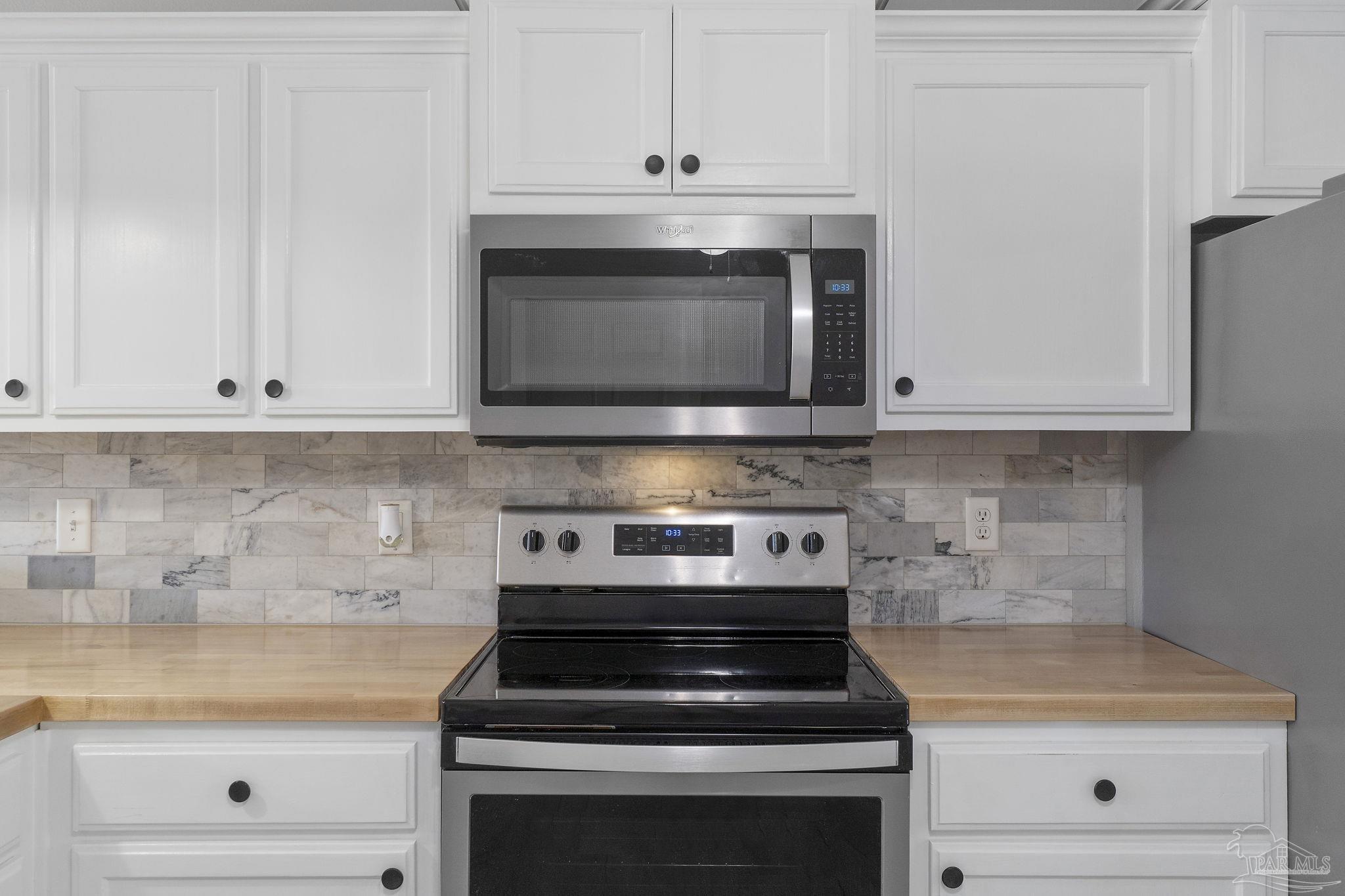 7253 Pro Lane Milton, FL 32570 - Photo 13 of 33 a stove top oven sitting inside of a kitchen