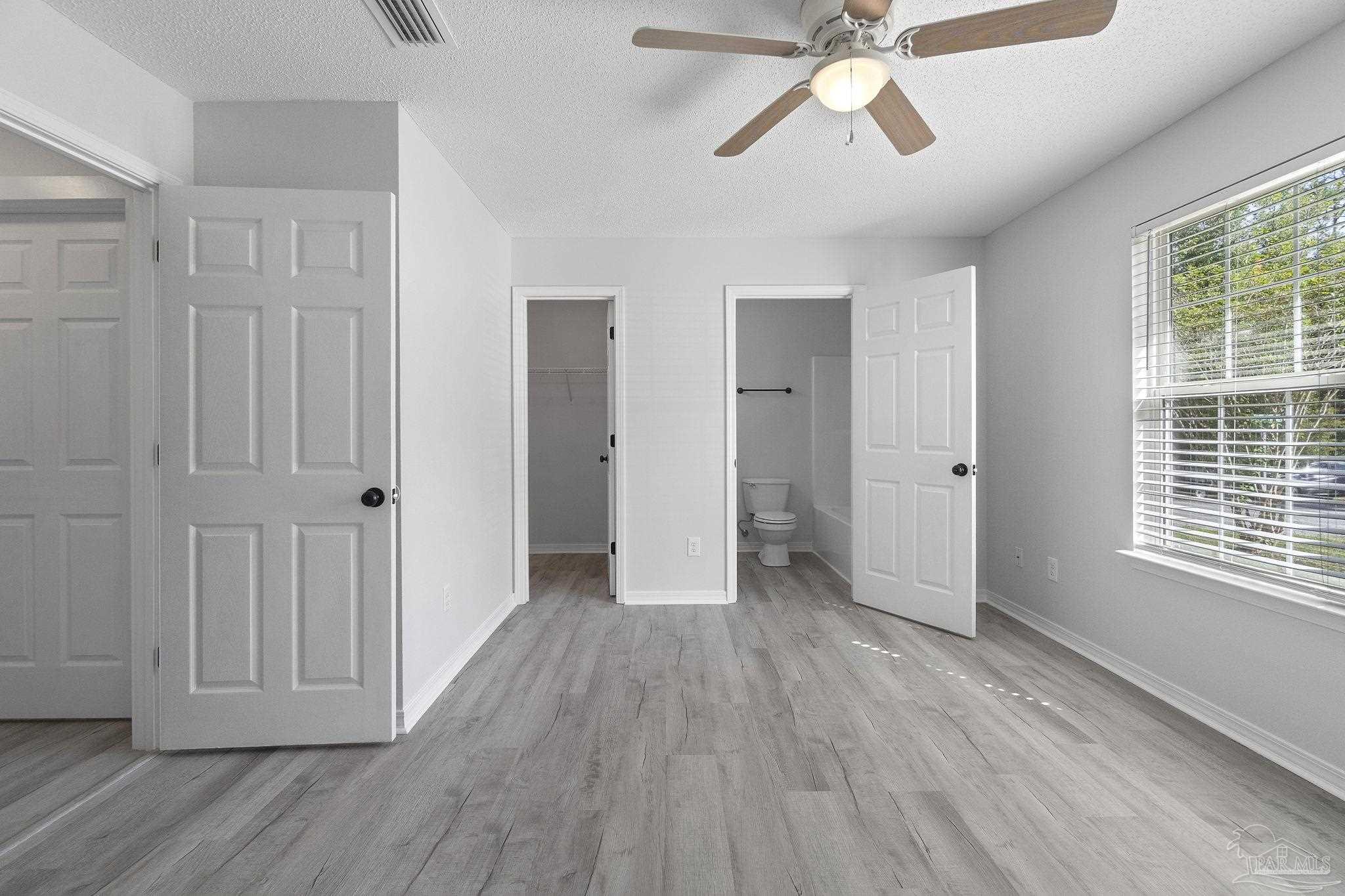 7253 Pro Lane Milton, FL 32570 - Photo 16 of 33 a view of empty room with wooden floor and fan