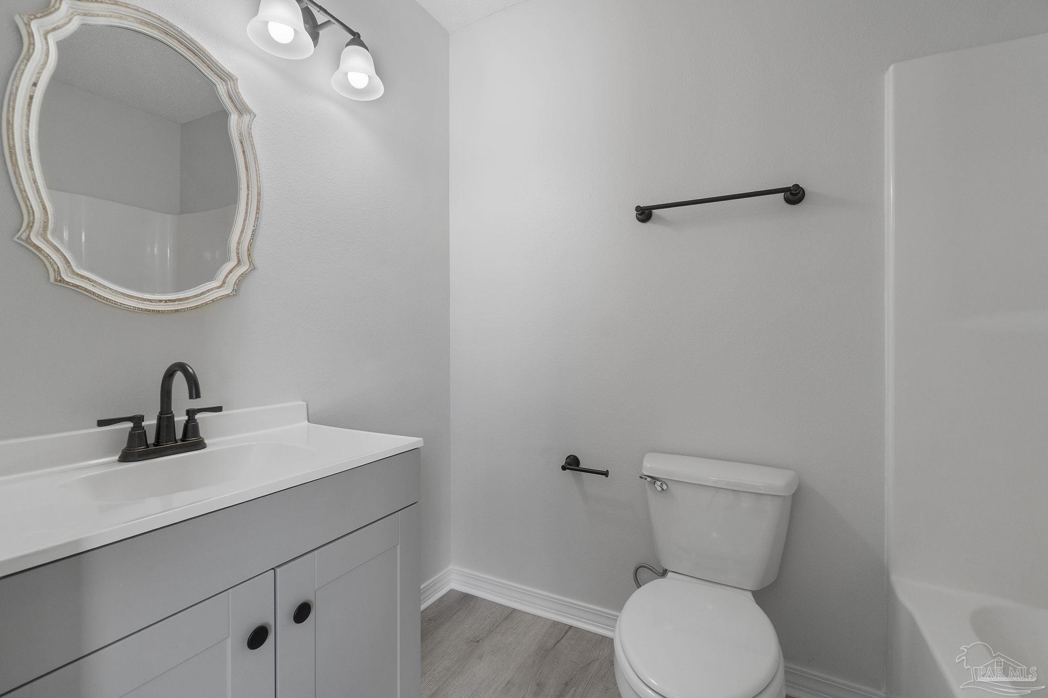 7253 Pro Lane Milton, FL 32570 - Photo 19 of 33 a bathroom with a toilet sink and mirror