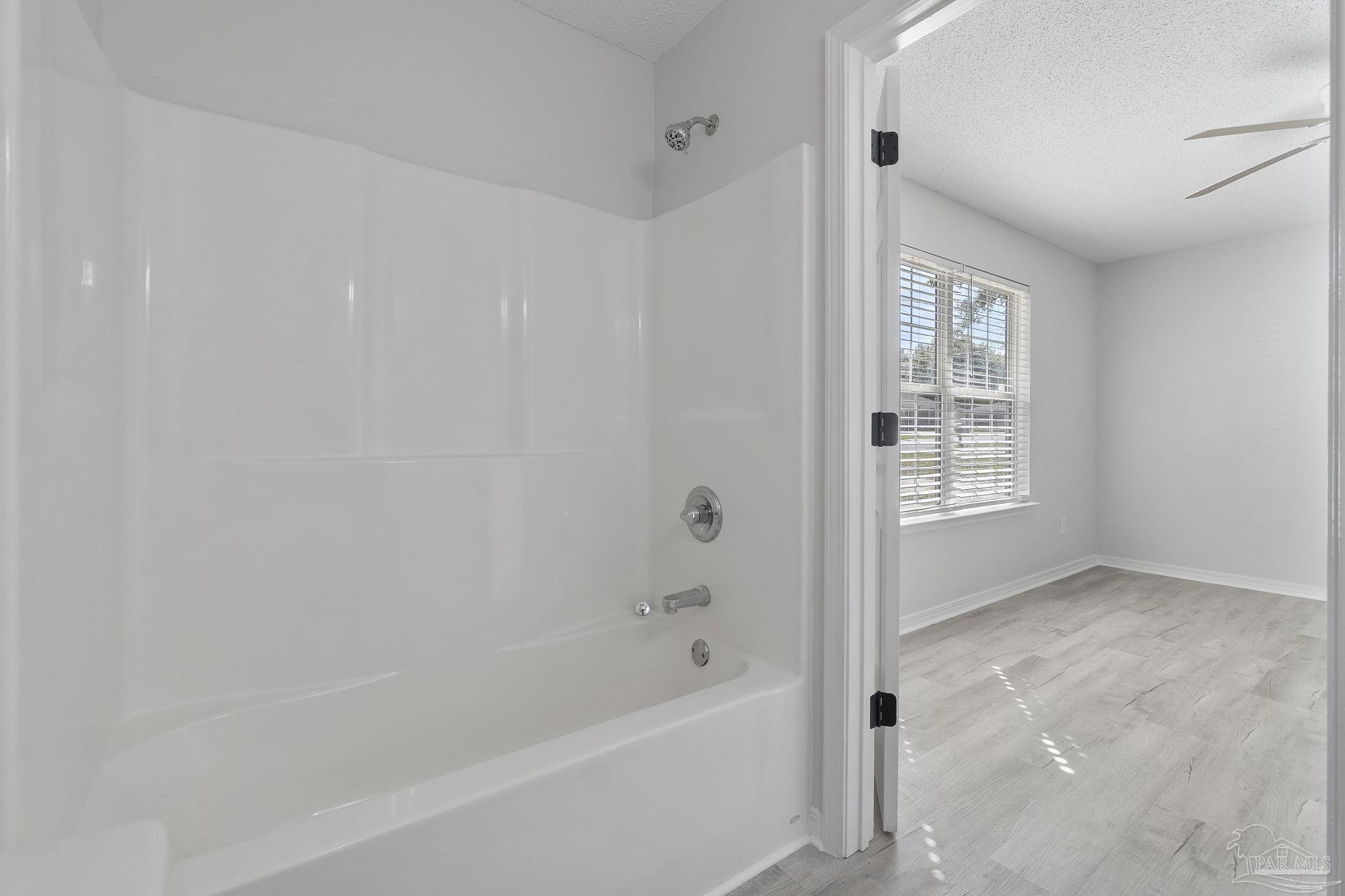 7253 Pro Lane Milton, FL 32570 - Photo 20 of 33 a bathroom with a bathtub and shower