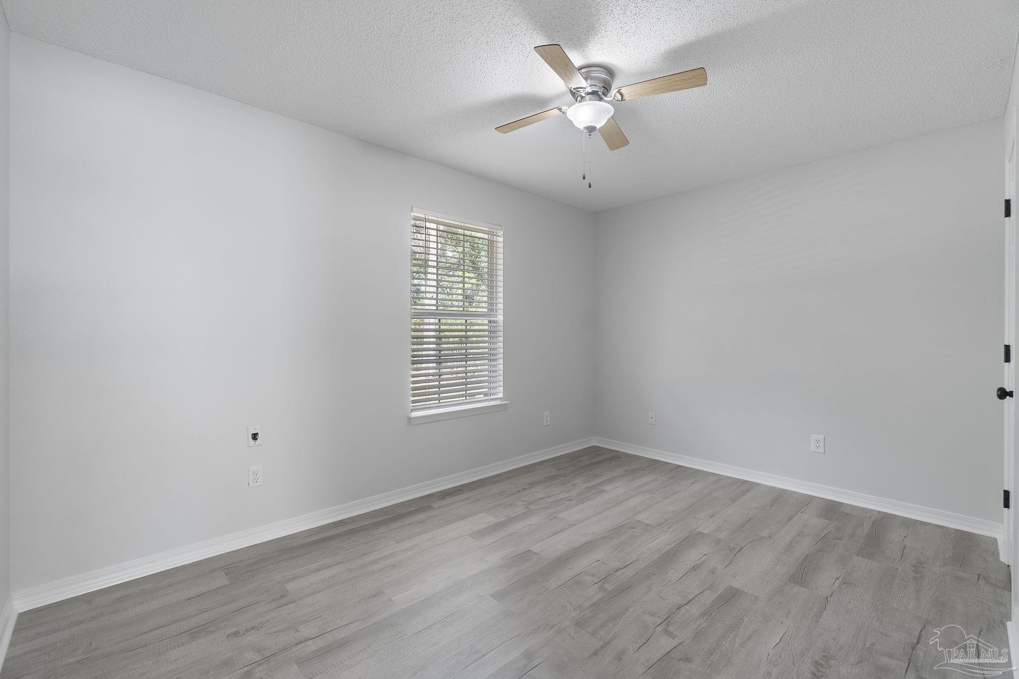 7253 Pro Lane Milton, FL 32570 - Photo 22 of 33 wooden floor in an empty room with a window