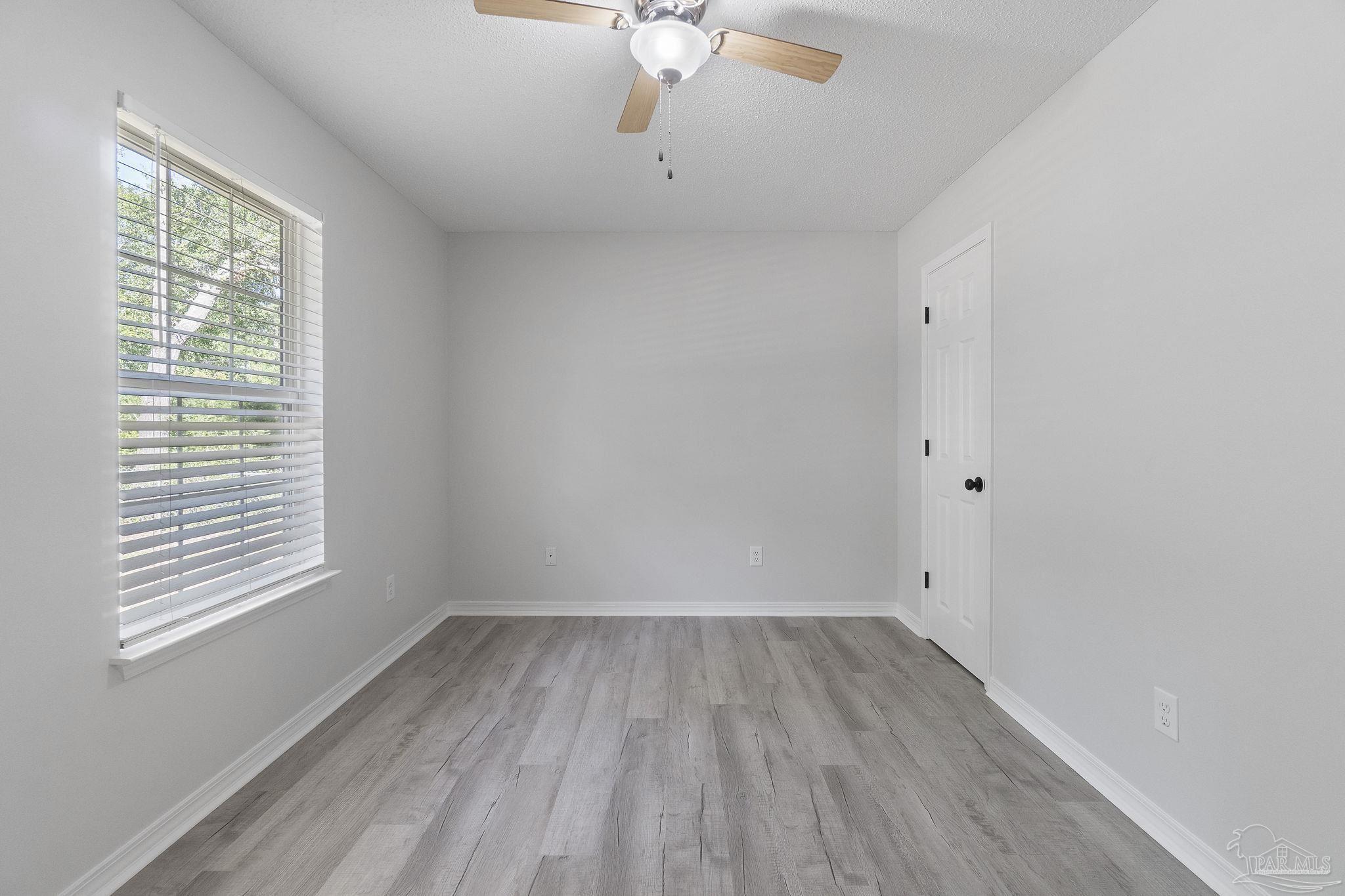 7253 Pro Lane Milton, FL 32570 - Photo 24 of 33 a view of a room with wooden floor and fan