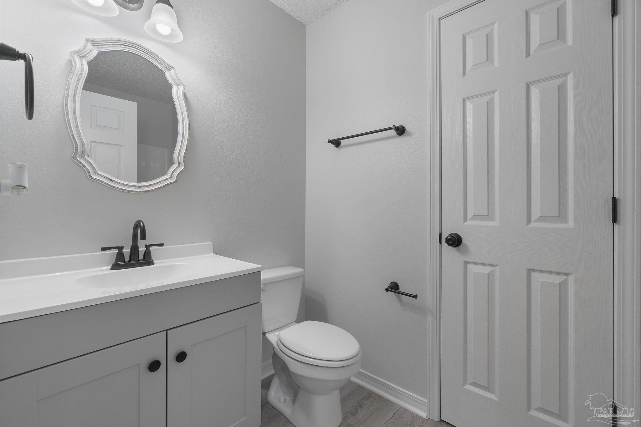 7253 Pro Lane Milton, FL 32570 - Photo 25 of 33 a bathroom with a sink a toilet and a mirror