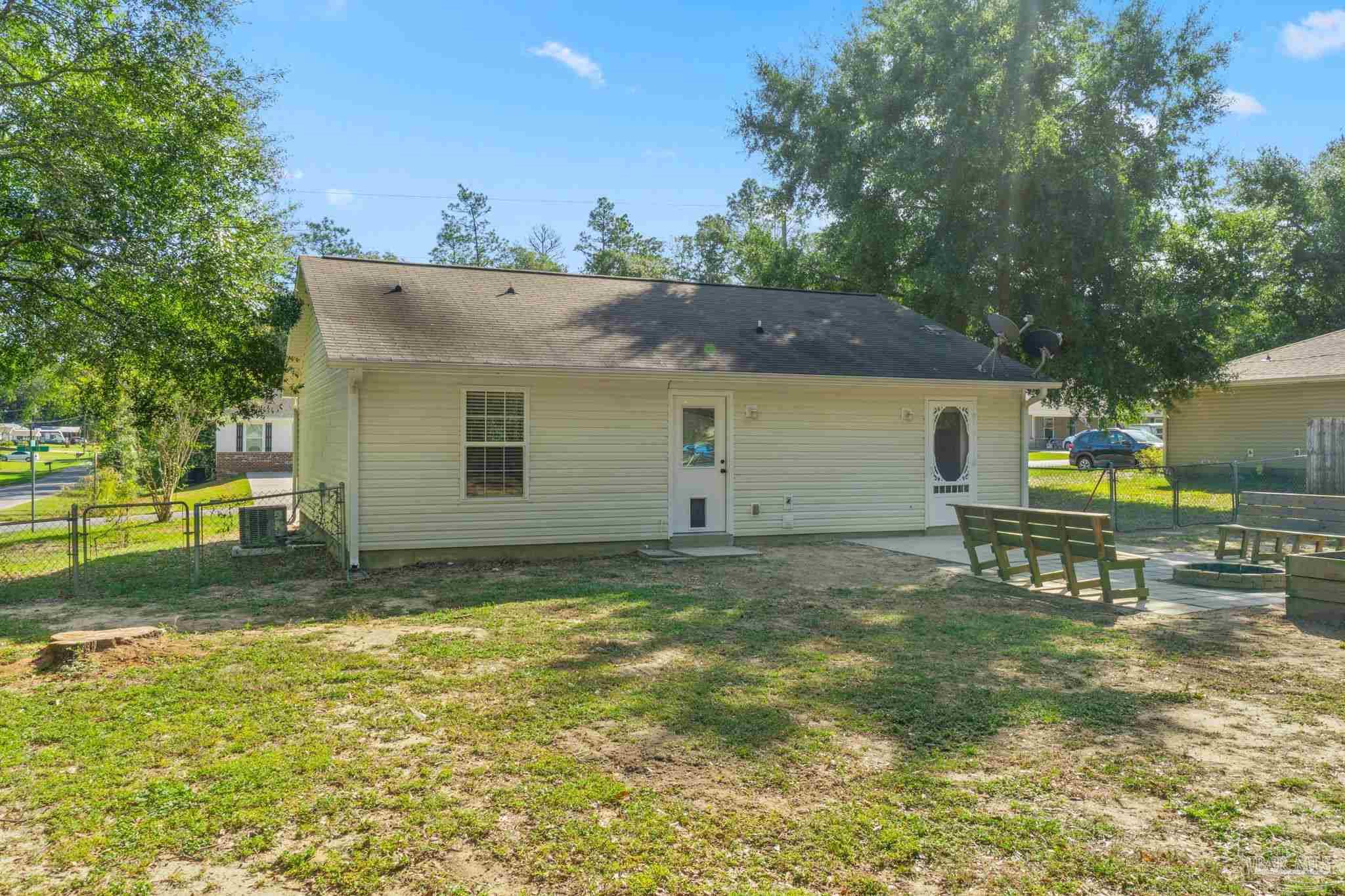 7253 Pro Lane Milton, FL 32570 - Photo 29 of 33 a view of a backyard with table and chairs and a slide
