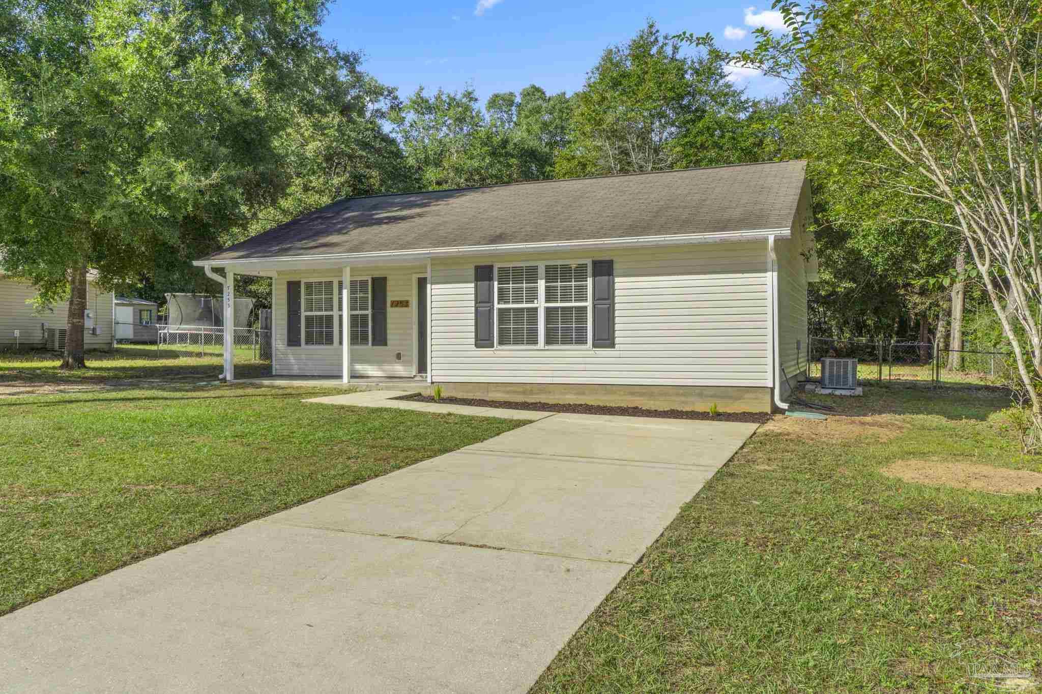 7253 Pro Lane Milton, FL 32570 - Photo 3 of 33 front view of a house with a yard