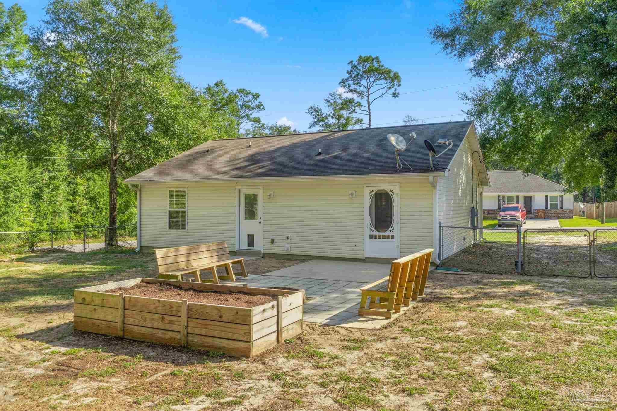 7253 Pro Lane Milton, FL 32570 - Photo 32 of 33 a front view of a house with swimming pool and sitting area
