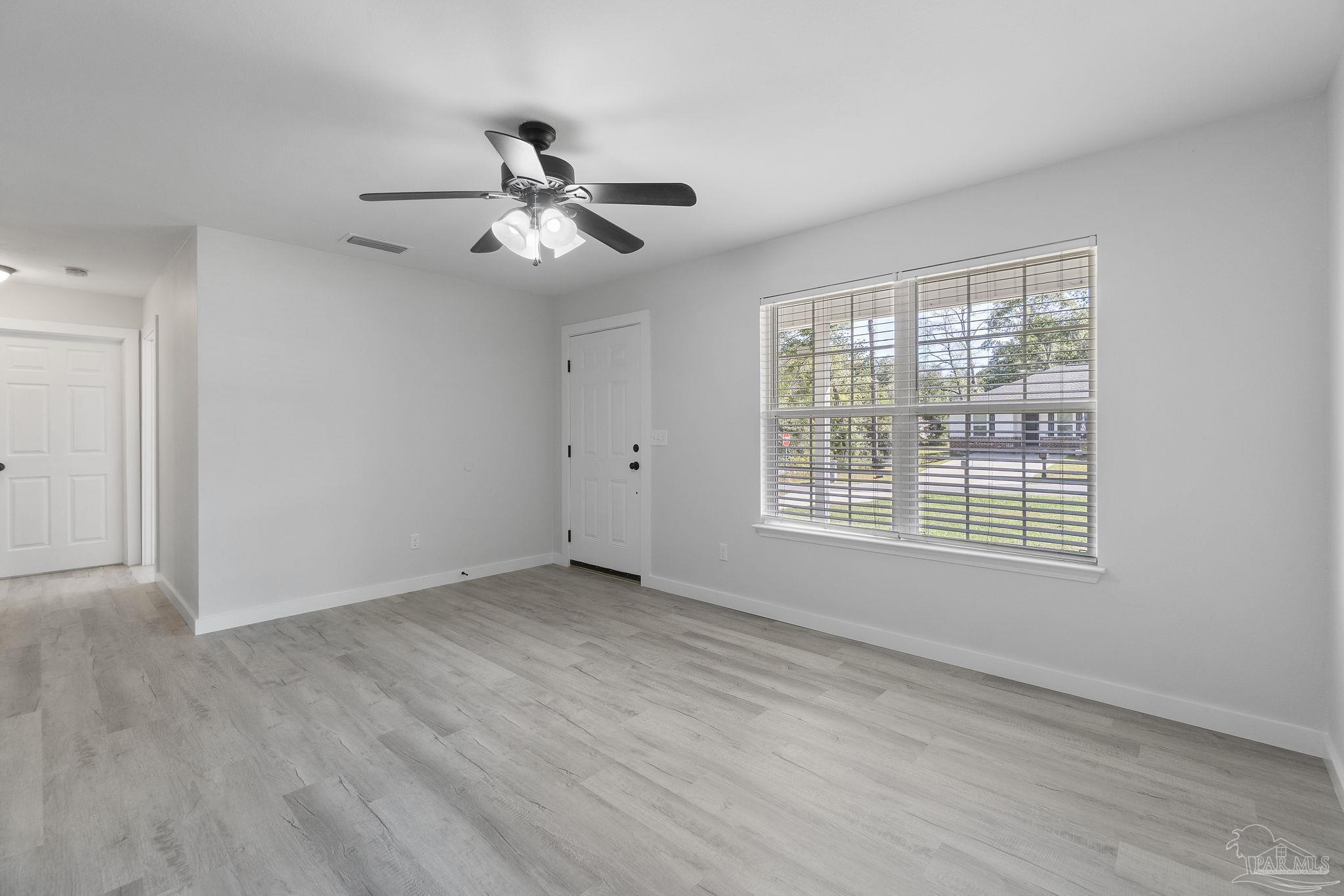 7253 Pro Lane Milton, FL 32570 - Photo 7 of 33 a view of an empty room with a window
