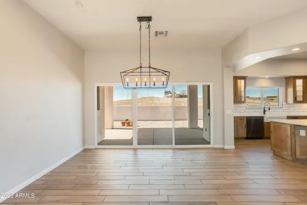 a view of a kitchen with a sink and wooden floor