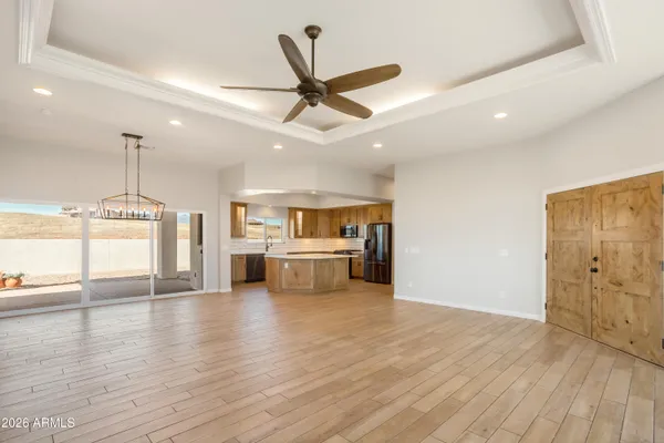 a large kitchen with stainless steel appliances granite countertop a sink a stove and refrigerator
