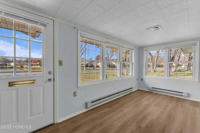 wooden floor in an empty room with a window
