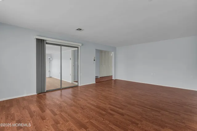 a view of an empty room and wooden floor