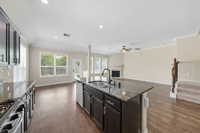 a kitchen with sink refrigerator and microwave