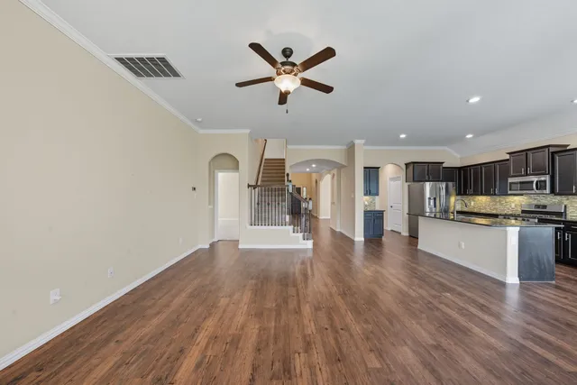 a view of a kitchen with a sink cabinets and wooden floor